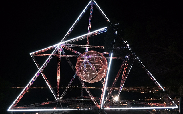 Large geometric light installation at night 