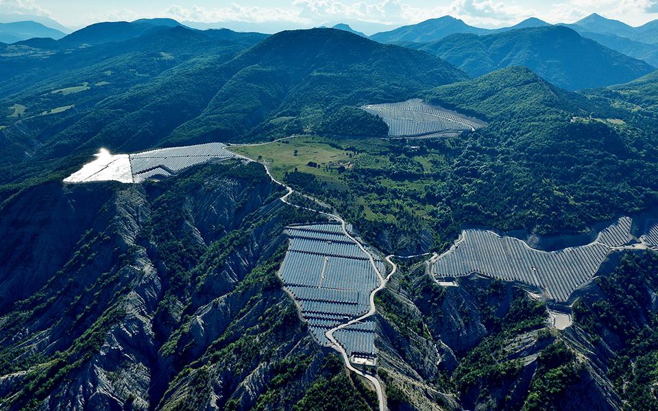 Aerial view of large-scale utility solar installation in mountains